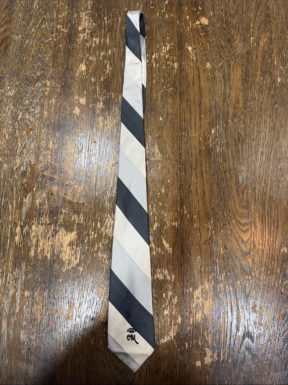 Striped Black and Cream Men's Tie with Subtle Monogram